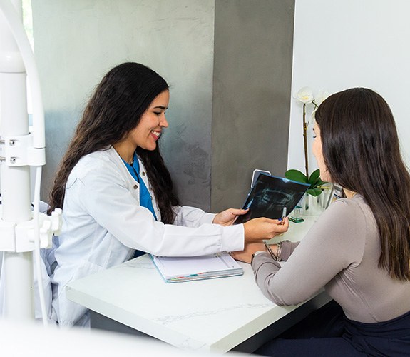 Dentist discussing cost of a root canal treatment in Aurora