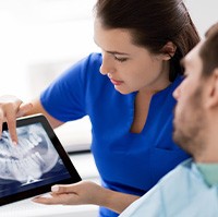 Dentist reviewing patient’s X-ray