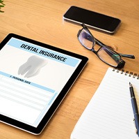 Dental insurance paperwork on tablet