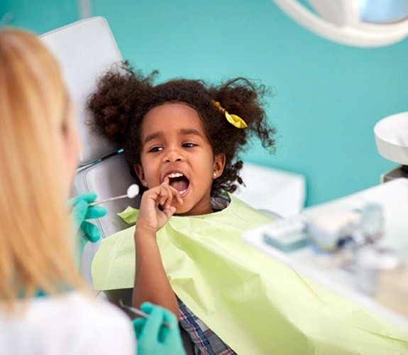 Little boy on dental chair with female dentist