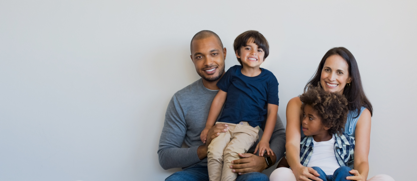 Family of four smiling