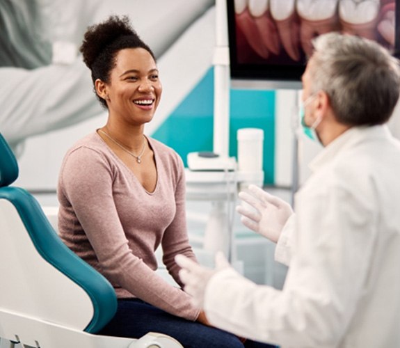 Dental receptionist speaking with patient 