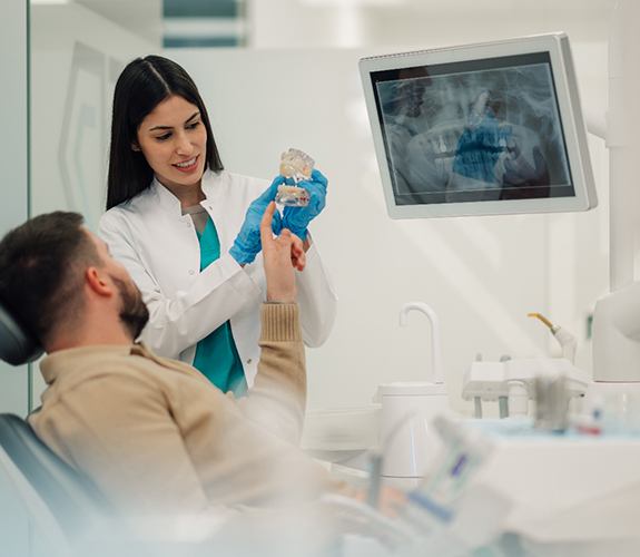Dentist talking to male patient