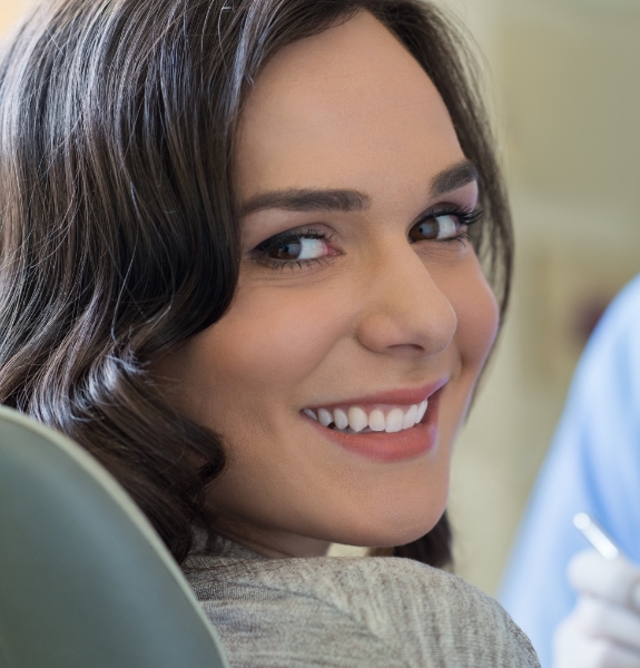 woman smiling over shoulder at camera