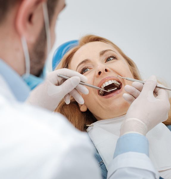 dentist peaking to patient about teeth