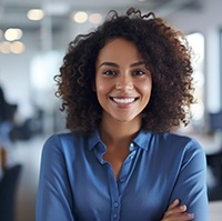 Woman in blue blouse showing off damage-free smile