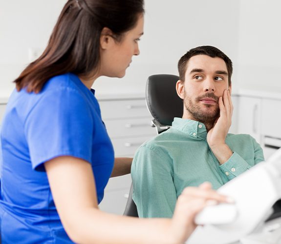 Man at dental practice in pain