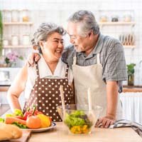 Couple smiling with dental implants in Aurora