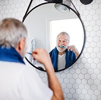 Older man brushing teeth