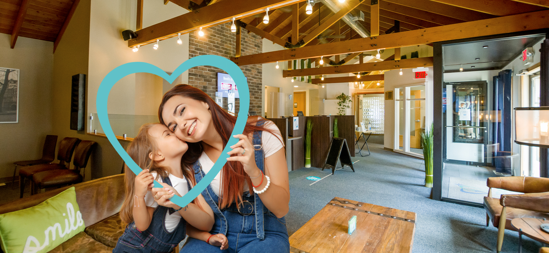 Daughter kissing mother on cheek in Aurora dental waiting room