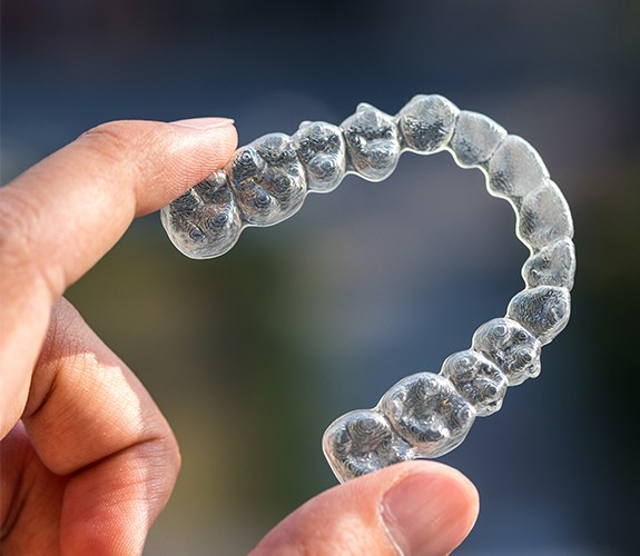 hand holding Clear Aligners tray