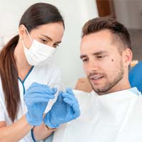 Man learning about the cost of Clear Aligners treatment
