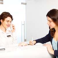 Patient at dental office front desk paying for Clear Aligners