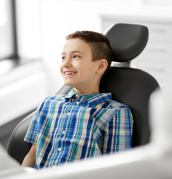 young boy smiling in exam chair