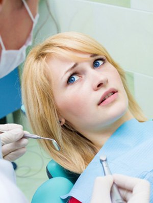 Woman afraid in the dental chair