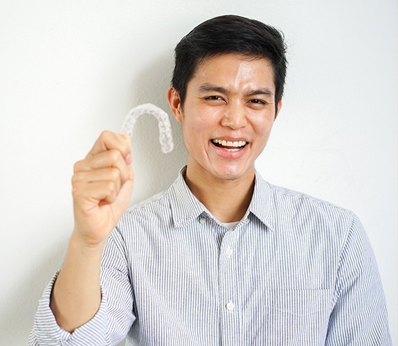 man holding tray and smiling