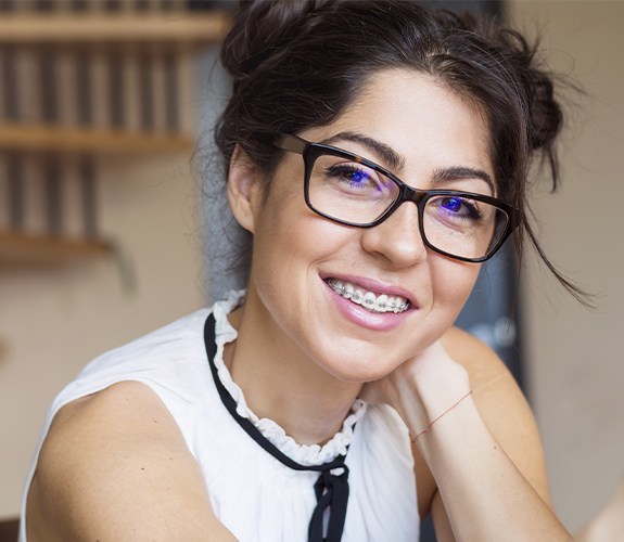 woman with metal braces and glasses