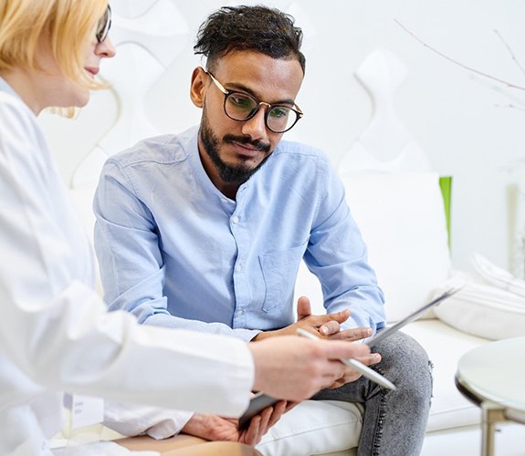 Man learning gum disease in Aurora