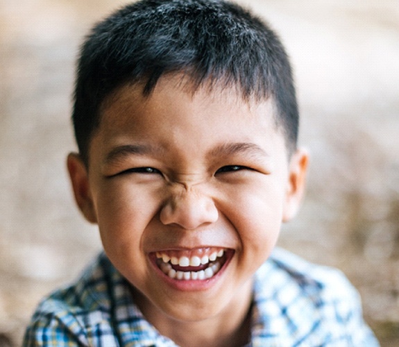 Boy smiling after Phase 1 orthodontics in Aurora, IL