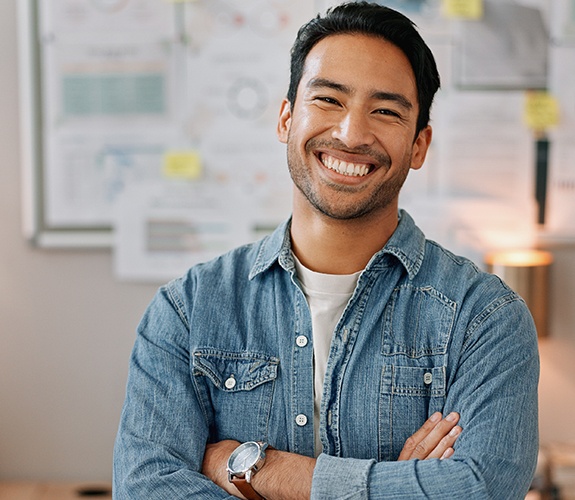 Man wearing denim jacket and smiling after a root canal