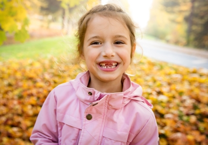 girl smiling without two front teeth
