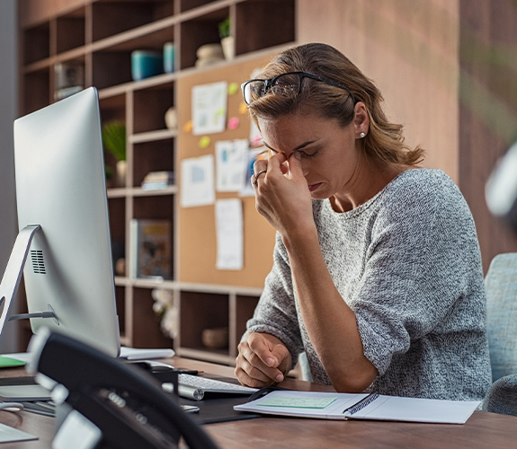 woman tired sitting at desk