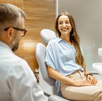 Young woman learning about the cost of veneers   