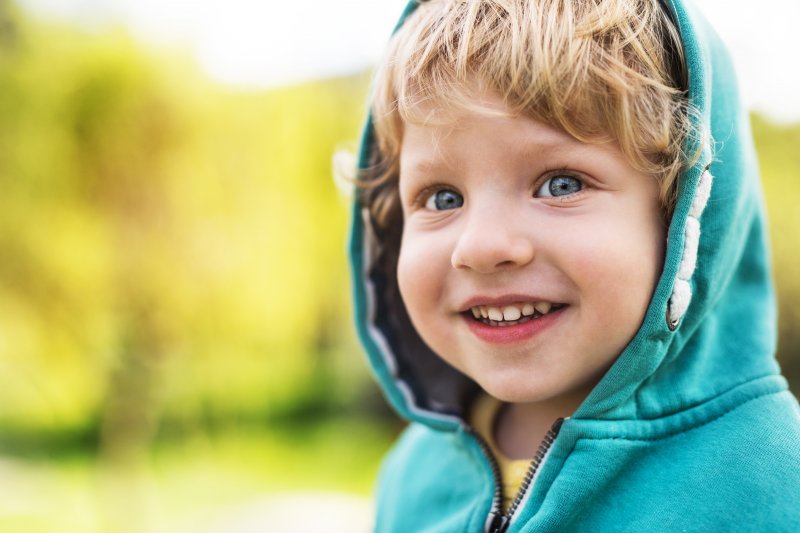 Little boy sitting and smiling