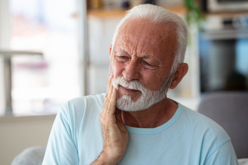 man experiencing tooth pain